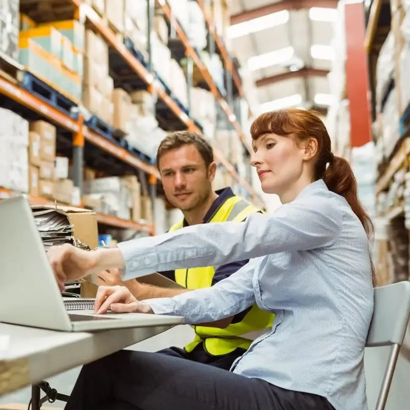 people on computer in a warehouse